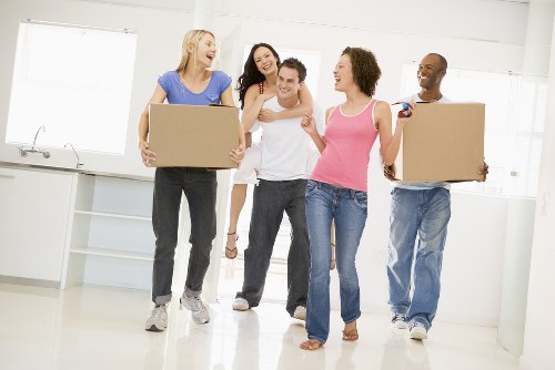 Removal van and moving boxes in Colliers Wood street setting