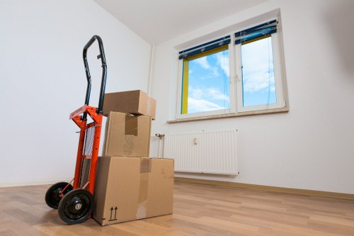 Professional man and van moving items through a residential street in Colliers Wood