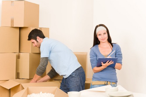 Packed office boxes and labelled items for a business relocation