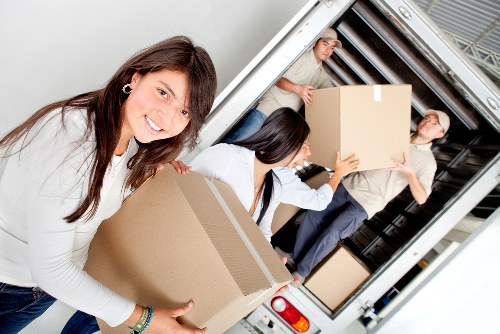 Local moving team handling boxes in Colliers Wood